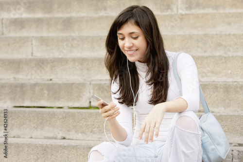 Photo: Young woman listening music Young woman listening music