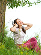 Beautiful Young Woman with Headphones Outdoors. Enjoy Music