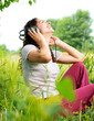 Beautiful Young Woman with Headphones Outdoors. Enjoy Music