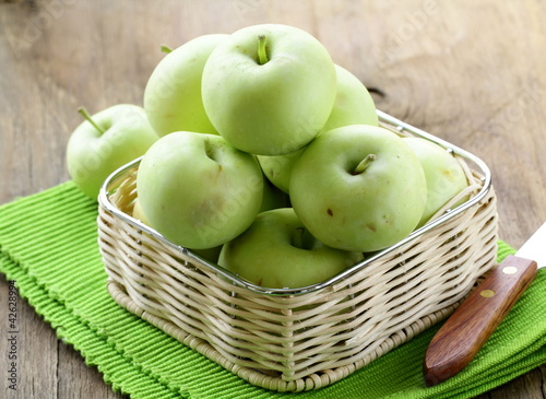 Photo: green ripe organic apples in the basket green ripe organic apples in the basket