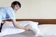 Young maid woman preparing bedroom