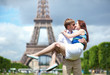 Man carrying his girlfriend in his arms in Paris