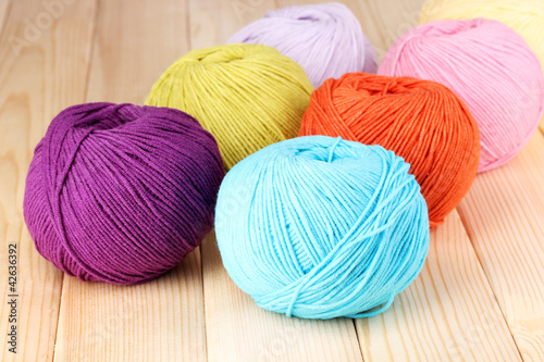 Photo: Knitting yarn on wooden background Knitting yarn on wooden background
