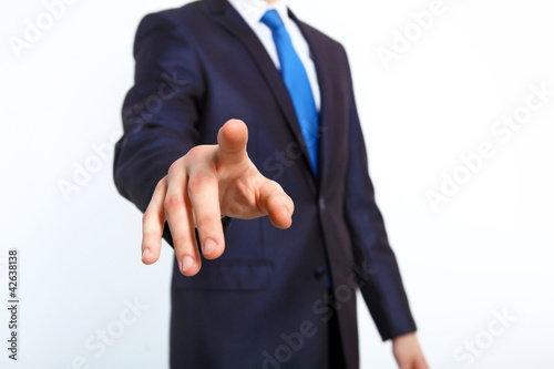 Photo: Businessman pushing a button with his finger Businessman pushing a button with his finger