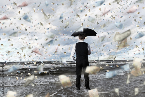 Photo: Money rain and businessman with umbrella Money rain and businessman with umbrella