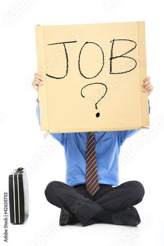 Photo: Businessman holding the text looking for a job Businessman holding the text looking for a job