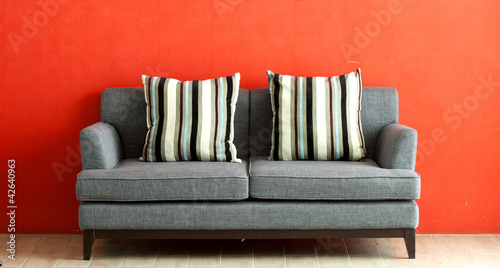 Photo: gray sofa put on red stucco background gray sofa put on red stucco background