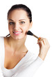 Foto: Young woman with make up brush, on white Young woman with make up brush, on white