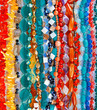 Lot of colored beads from different minerals and stone backgroun