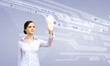 Foto: Businesswoman and touch screen technology Businesswoman and touch screen technology
