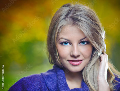 Photo: Close Up Portrait of Beautiful blonde girl posing in a forest Close Up Portrait of Beautiful blonde girl posing in a forest