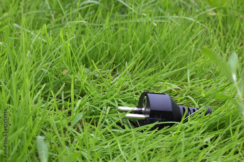 Foto: switchplug lying on the grass switchplug lying on the grass