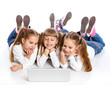 Photo: Three attractive girl using a laptop Three attractive girl using a laptop
