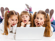 Photo: Three attractive girl using a laptop Three attractive girl using a laptop