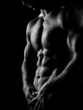 strong athletic man on dark background