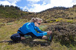Woman exercising and stretching in mountains