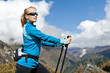 Woman nordic walking and exercising in mountains