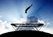 Photo: silhouette of gymnast on trampoline in sunset silhouette of gymnast on trampoline in sunset