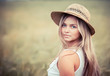 portrait of the rural girl in a straw hat