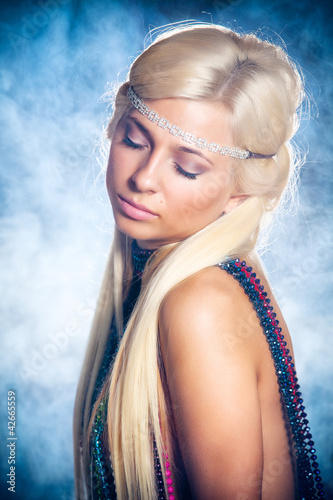 Photo: Portrait of beautiful young woman in beads Portrait of beautiful young woman in beads