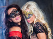 Photo: happy young girls under masks on the party happy young girls under masks on the party