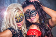 Photo: Portrait happy young girls under masks on the party Portrait happy young girls under masks on the party