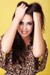 Foto: Smiling woman running hands through her hair Smiling woman running hands through her hair