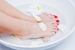 woman spa pedicure foot treatment with water and flower