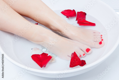 Photo: woman spa pedicure foot treatment with water and flower woman spa pedicure foot treatment with water and flower