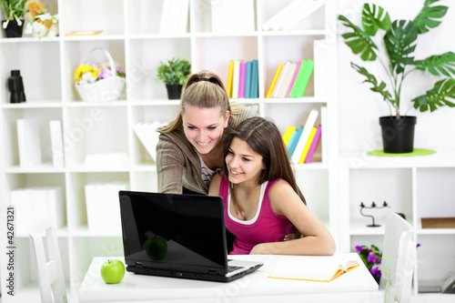 Photo: Teenager girl earning with sister Teenager girl earning with sister