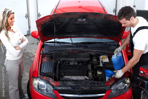 Photo: Auto mechanic and a client woman. Auto mechanic and a client woman.