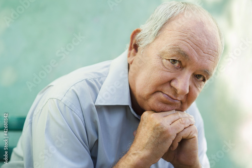 Photo: Portrait of sad bald senior man looking at camera Portrait of sad bald senior man looking at camera