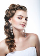 Beautiful bride in white dress. Festive coiffure and makeup