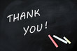 Thank you written with chalk on a smudged blackboard