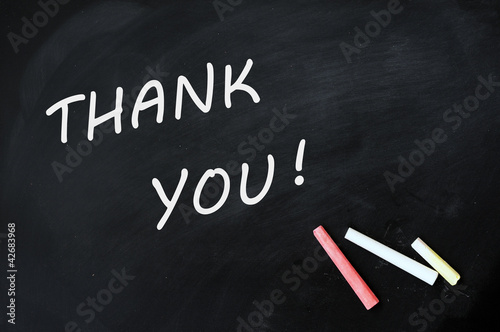 Photo: Thank you written with chalk on a smudged blackboard Thank you written with chalk on a smudged blackboard