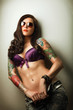 Beautiful girl with stylish make-up and tattooed arms..