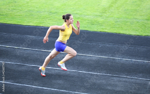 Photo: Girl running on the track Girl running on the track