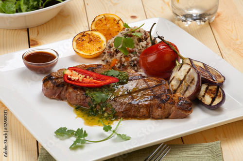 Photo: Piece of Medium Rare Steak with Spicy Herb Sauce Piece of Medium Rare Steak with Spicy Herb Sauce