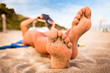 Woman reading a book on the beach.