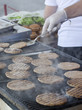 Hamburgers being cooked on the hot grill
