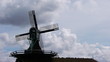 Small wind mill silhouette and dramatic sky