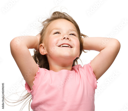 Photo: Little girl is stretching and rising hands up Little girl is stretching and rising hands up