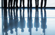 Reflection of business people standing in a row at window