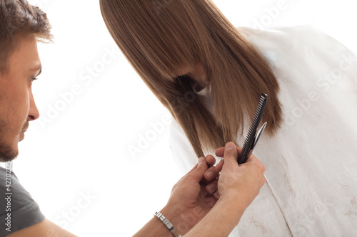 Photo: Professional hairdresser with long hair model, isolated on white Professional hairdresser with long hair model, isolated on white