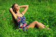 Beautiful young woman relaxing in grass