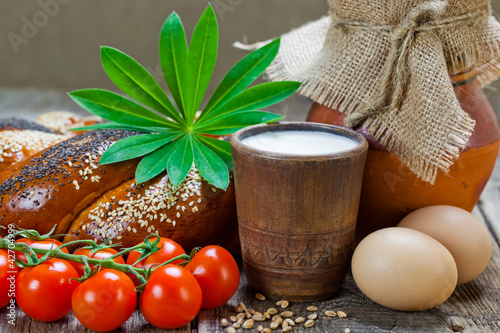 Photo: Composition of milk on the bread, the old background Composition of milk on the bread, the old background
