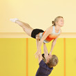 Man raising woman on hands