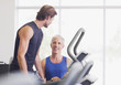 Men talking on treadmill in gymnasium