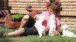 Happy man playing with a maltese puppy