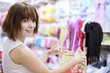 Photo: The girl in shop tries on clothes The girl in shop tries on clothes